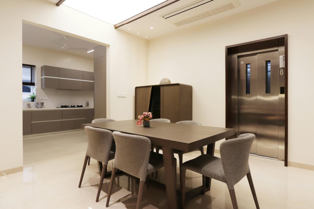 Contemporary dining area with table, chairs, and stylish kitchen view.