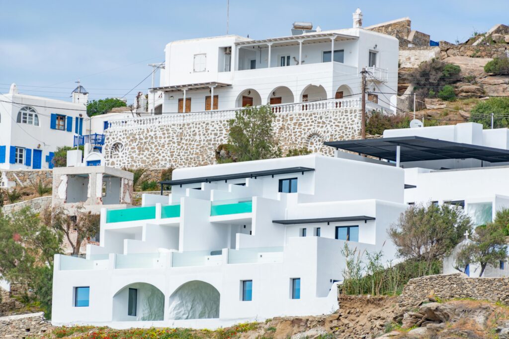 Whitewashed buildings on a Greek island showcasing traditional architecture with sea views.