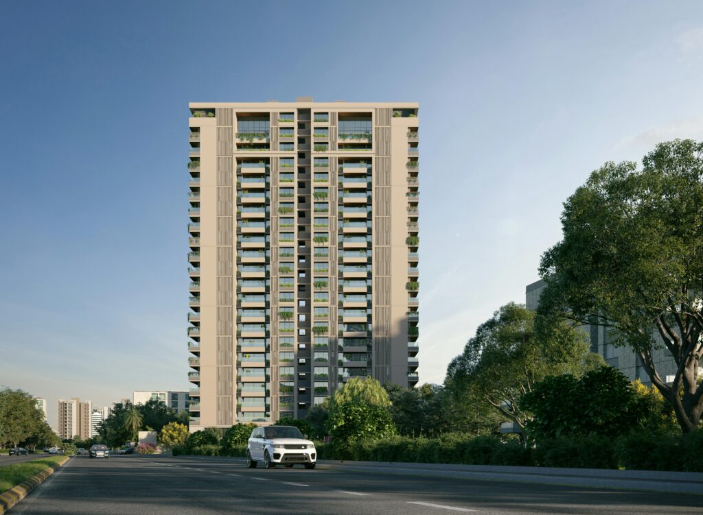 A contemporary high-rise apartment building in Ahmedabad, India with clear skies.
